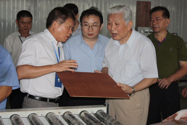 林宗棠部长（右二）在廖军文主任（右一）陪同下参观兴利尊典公司生产线